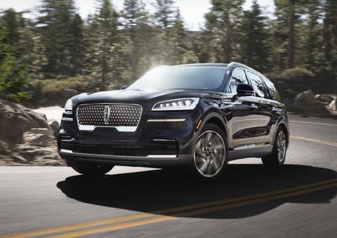 A Lincoln Aviator® SUV is being driven on a winding mountain road | Performance Lincoln Bountiful in Bountiful UT