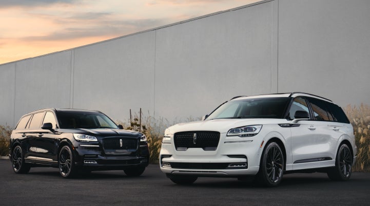 Two Lincoln Aviator® SUVs are shown with the available Jet Appearance Package | Performance Lincoln Bountiful in Bountiful UT