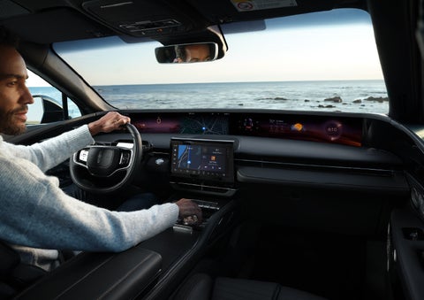 A driver of a parked 2024 Lincoln Nautilus® SUV takes a relaxing moment at a seaside overlook while inside his Nautilus. | Performance Lincoln Bountiful in Bountiful UT