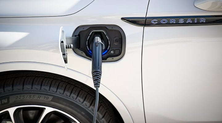 An electric charger is shown plugged into the charging port of a Lincoln Corsair® Grand Touring
model. | Performance Lincoln Bountiful in Bountiful UT